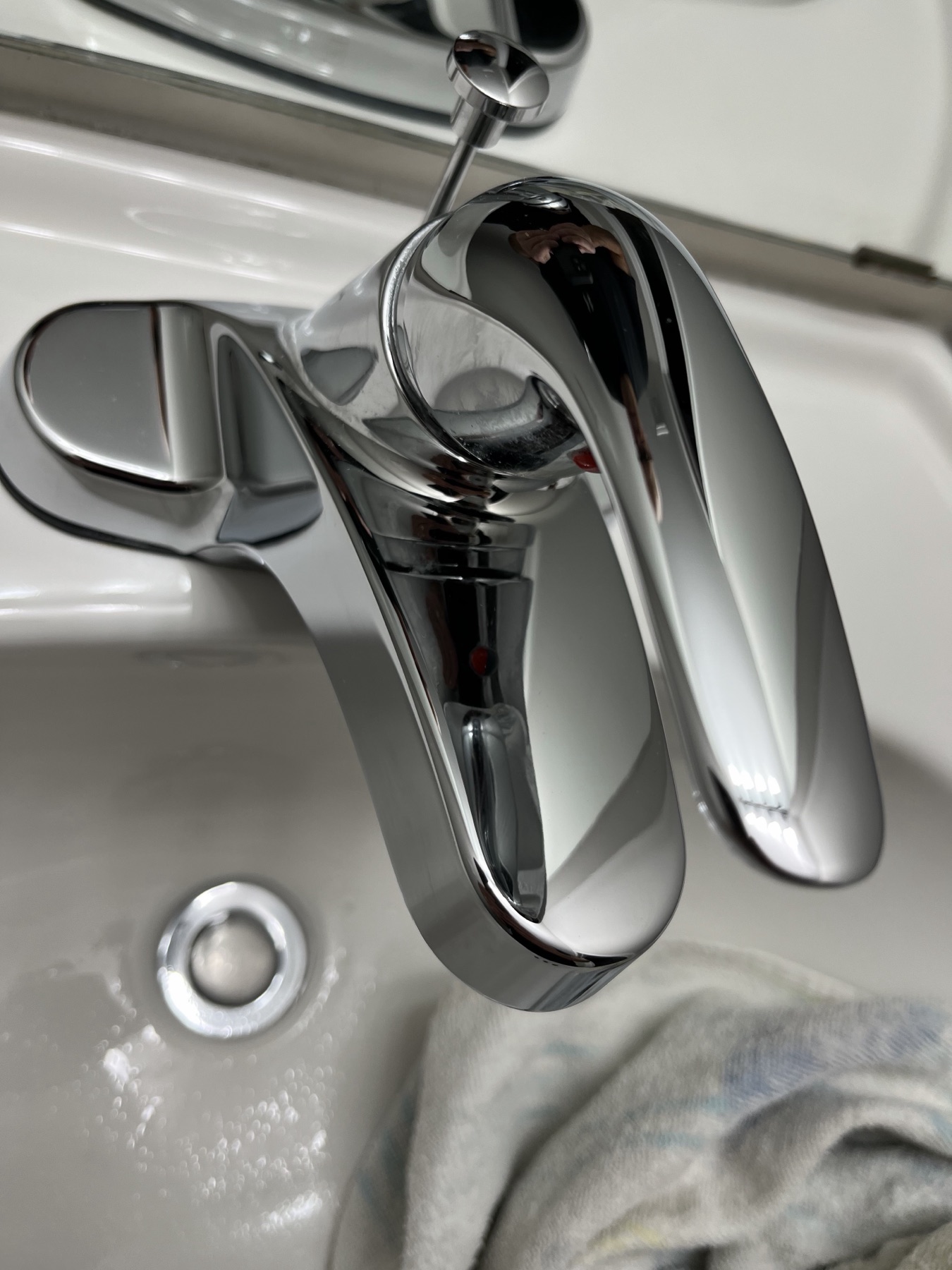 Polished bathroom faucet detail after cleaning.
