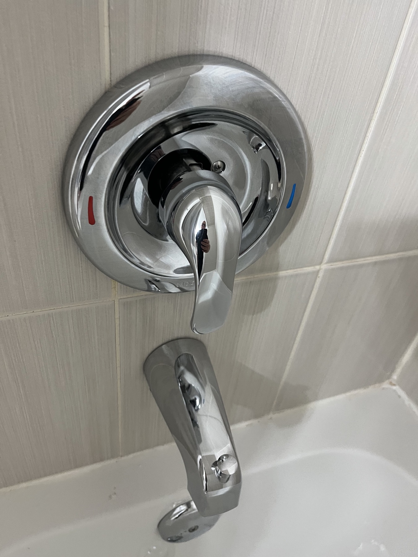 Clean shower tap and tub fixture after bathroom detail cleaning.