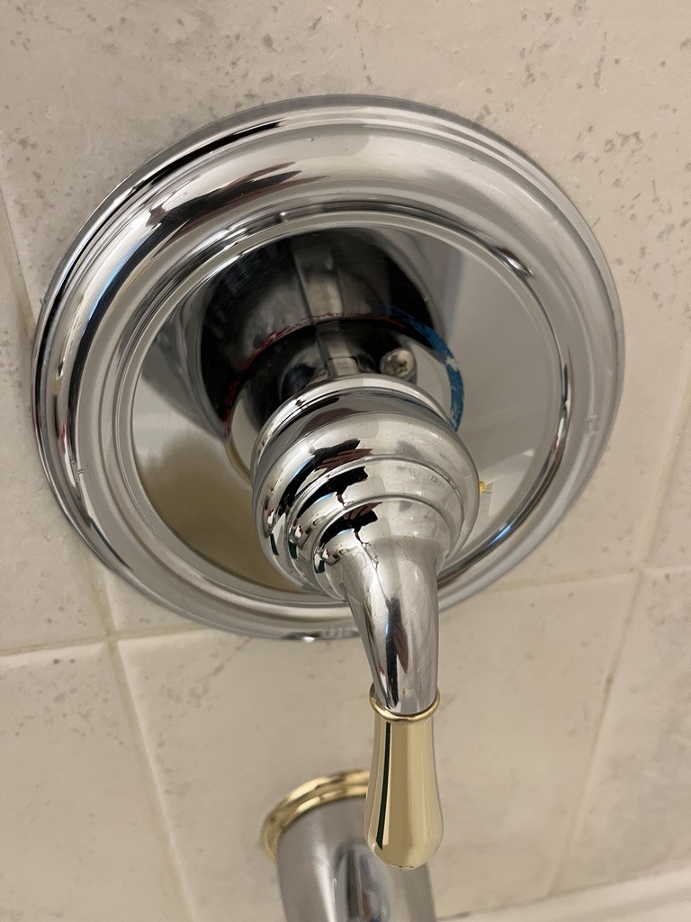 Clean shower fixture and surrounding tile after detail cleaning.