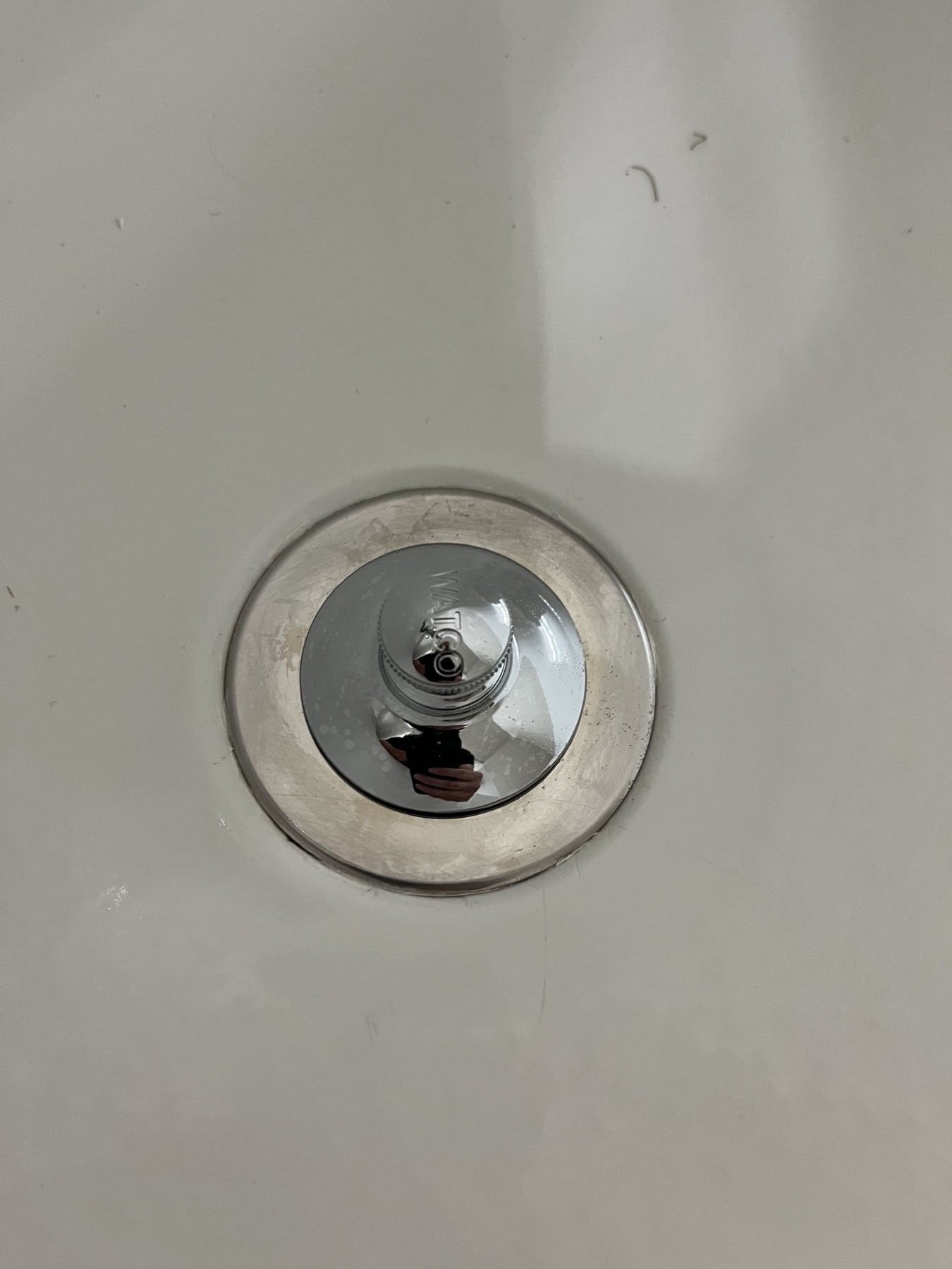 Clean bathtub stopper after bathroom detail cleaning.