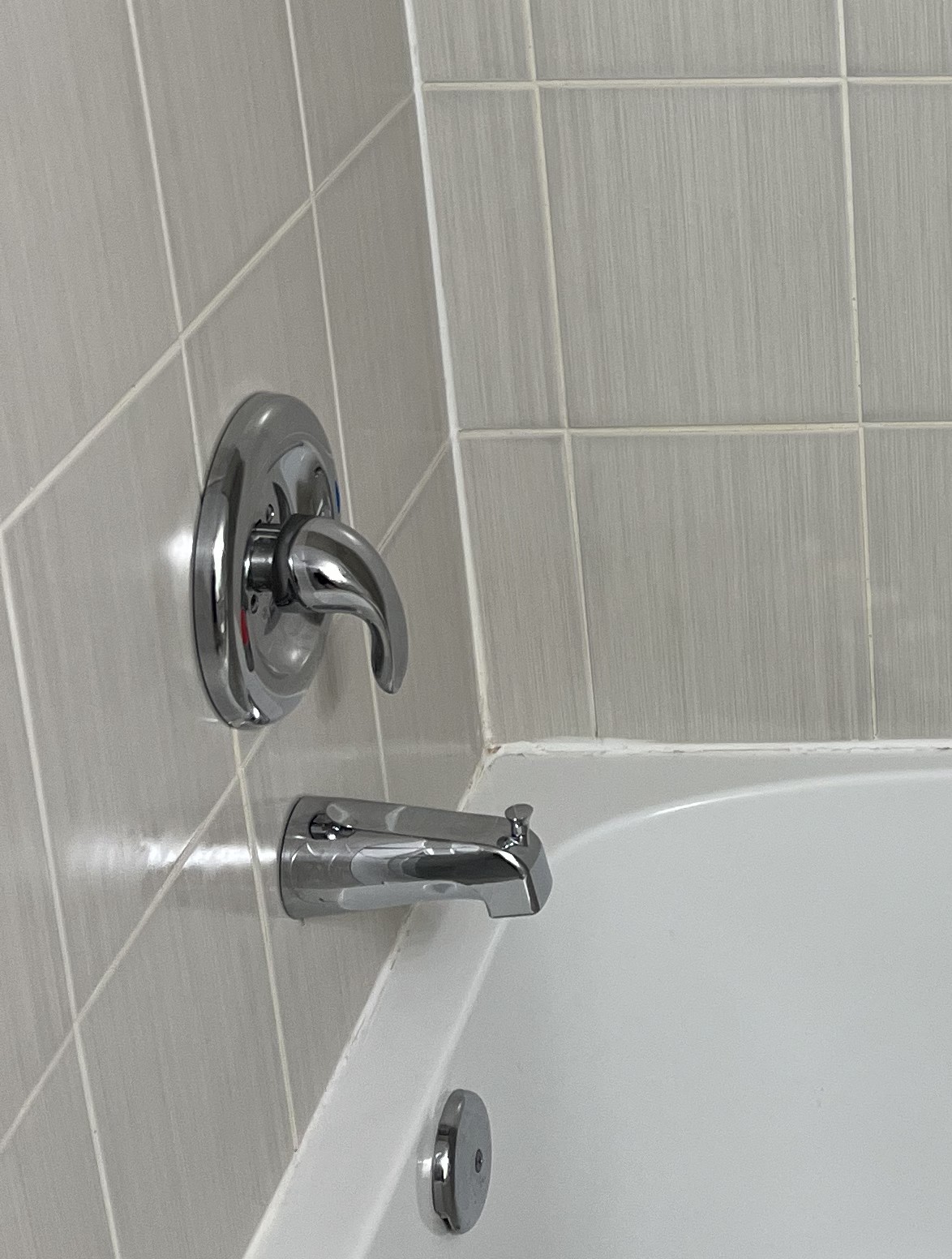 Clean tub and shower fixture area after bathroom detail cleaning.