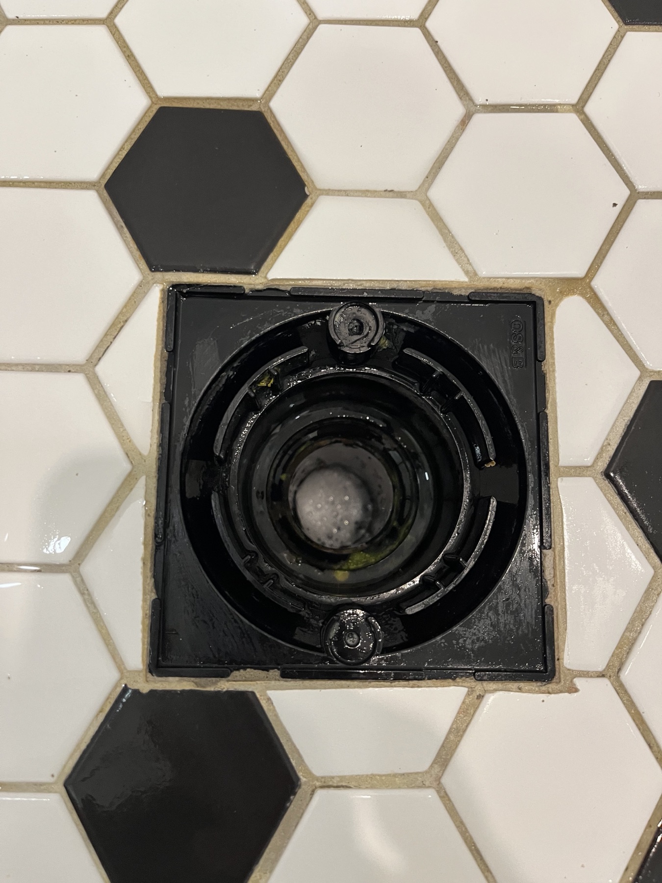 Clean shower drain after bathroom detail cleaning.